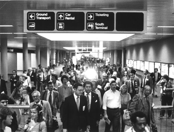 Airport Commissioner George Berry and Mayor Maynard Jackson lead members of the media on a tour of the new airport as part of the dedication ceremonies hype Sept. 18, 1980.