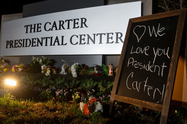 Flowers, candles and peanuts outside the Carter Presidential Center in Atlanta on Sunday.