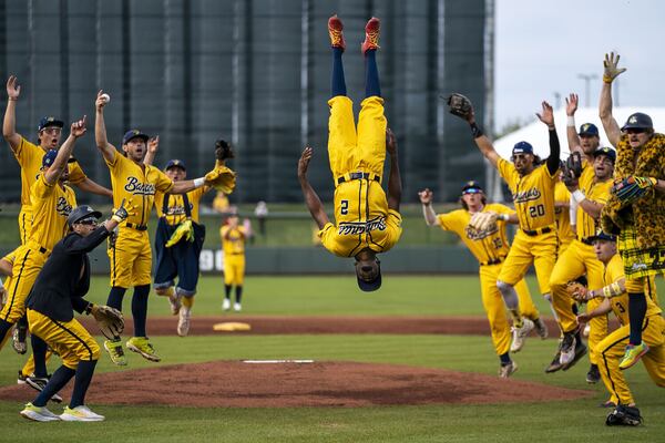 Savannah Banana Malachi Mitchell flips in the air as the team cheers before the start of a banana ball game in 2022.