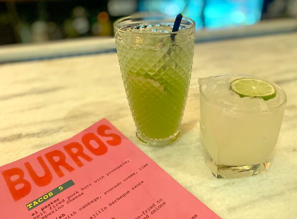 The beverage menu at Dos Burros includes a mezcal-based margarita (right) as well as nonalcoholic drinks, such as cucumber agua fresca (left). Ligaya Figueras/ligaya.figueras@ajc.com