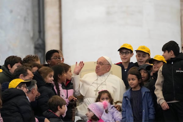 Pope Francis greets a group of children during his weekly general audience in St. Peter's Square at The Vatican, Wednesday, Nov.20, 2024. (AP Photo/Gregorio Borgia)