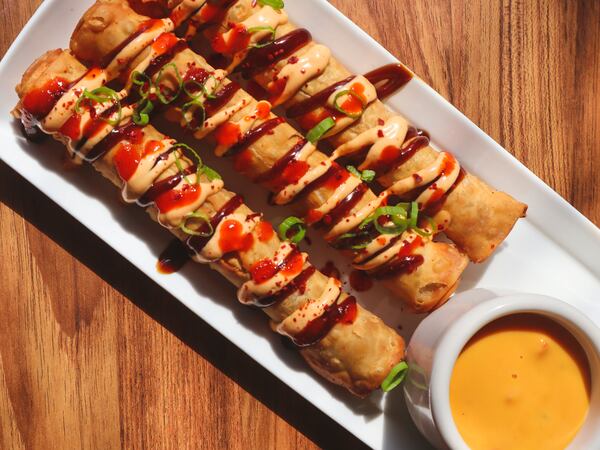 The beef eggroll taquitos at TKO are served with drizzles of hoisin, spicy mayo, Sriracha, scallions and nacho cheese. Courtesy of Colette Collins/TKO 