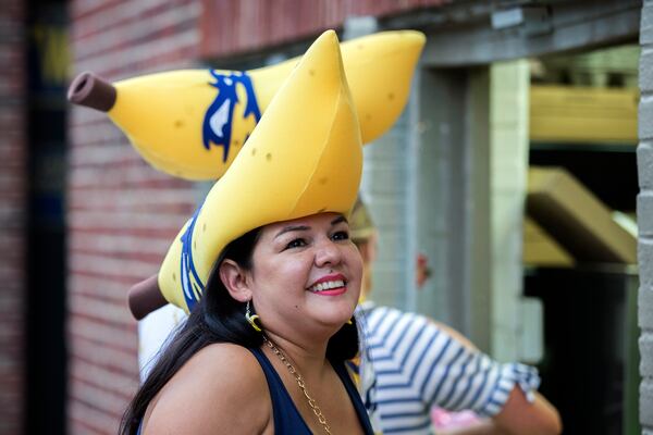 Two Savannah Bananas fans dressed in foam banana hats wait inline at a concession stand before the start of a game with the Holly Springs Salamanders at Historic Grayson Stadium. (AJC Photo/Stephen B. Morton)