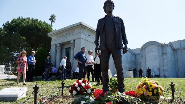 Guests gather around a statue of the late actor Anton Yelchin during a life celebration and statue unveiling for Yelchin at Hollywood Forever Cemetery on Sunday, Oct. 8, 2017, in Los Angeles. Yelchin died in June 2016 at the age of 27. (Photo by Chris Pizzello/Invision/AP)