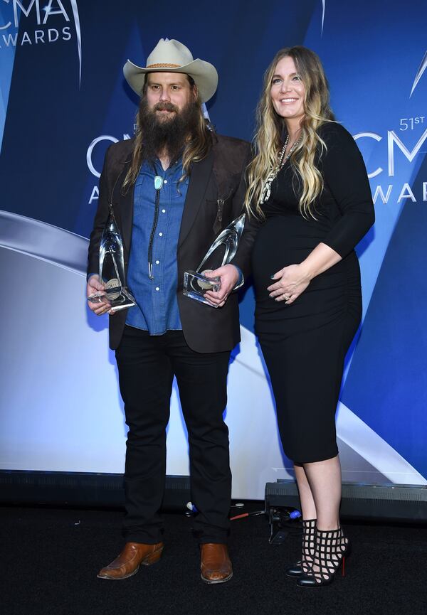  Musician Chris Stapleton and his wife Morgane Stapleton  in the press room with the awards for album of the year and male vocalist of the year. (Photo by Evan Agostini/Invision/AP)