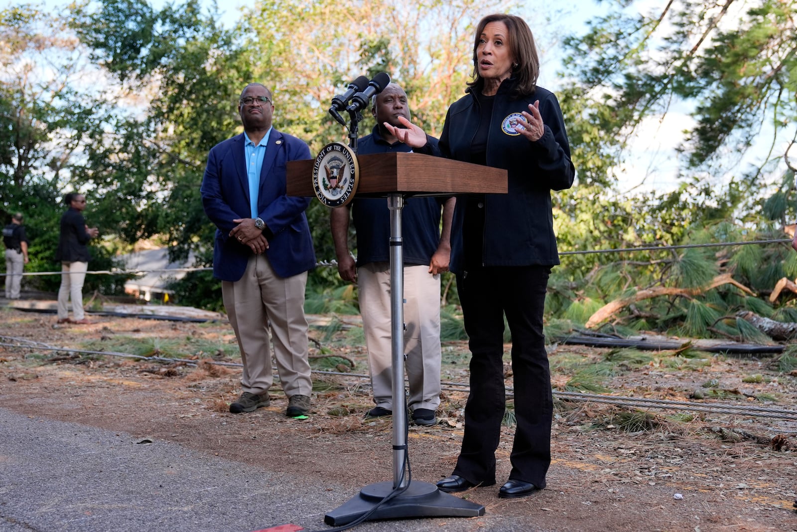 Democratic presidential nominee Vice President Kamala Harris speaks as she tours an area impacted by Hurricane Helene in Augusta, Ga., Wednesday, Oct. 2, 2024, as Augusta Mayor Garnett Johnson, left, and FEMA deputy director Erik Hooks listen. (AP Photo/Carolyn Kaster)