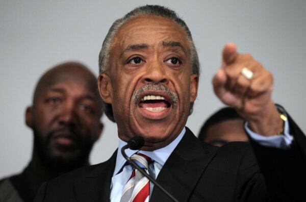 WASHINGTON, DC - APRIL 11: President and Founder of the National Action Network Rev. Al Sharpton (R) speaks as Tracy Martin, father of Trayvon Martin who was fatally shot by neighborhood watch captain George Zimmerman in Florida, listens during a news conference April 11, 2012 in Washington, DC. It has been reported that Zimmerman will be charged in the Trayvon Martin shooting according to Florida special prosecutor Angela Corey. (Photo by Alex Wong/Getty Images)