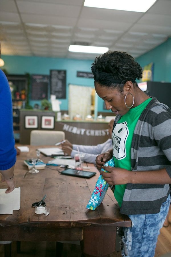 Carver Neighborhood Market employee Imani Willis wraps gifts for customers at Pride for Parents. Focused Community Strategies started Pride for Parents with one simple belief: Families would prefer to provide for themselves at Christmas than receive a handout. CONTRIBUTED BY BECCA STANLEY