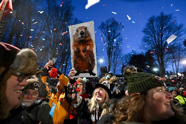 The crowd watches the festivities while waiting for Punxsutawney Phil, the weather prognosticating groundhog, to come out and make his prediction during the 139th celebration of Groundhog Day on Gobbler's Knob in Punxsutawney, Pa., Sunday, Feb. 2, 2025. (AP Photo/Barry Reeger)