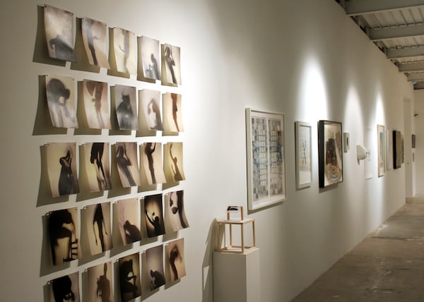 "Gathered" includes (from left): left to right: Chester Old's "Shadow Portraits," Steffen Sornpao's "Figure Hanging on Bar on Bar," Katherine Mitchell's "White Oak Night" and Philip Carpenter's "Scissors." CONTRIBUTED BY AMY KICKLIGHTER