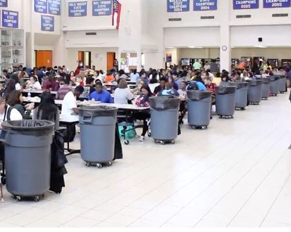 Trash cans are lined up in the cafeteria at	Gwinnett County’s Parkview High School. The school district has partnered with Gwinnett Clean & Beautiful to audit food waste. JENNA EASON/AJC