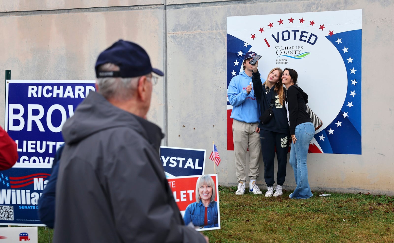 First time voters Efton, left, and Eliza Owens, center, take a selfie with their mother Kourtney Owens outside the St. Charles County Election Authority as early voting continues on Thursday, Oct. 31, 2024 in St. Peters, Mo. (Robert Cohen/St. Louis Post-Dispatch via AP)