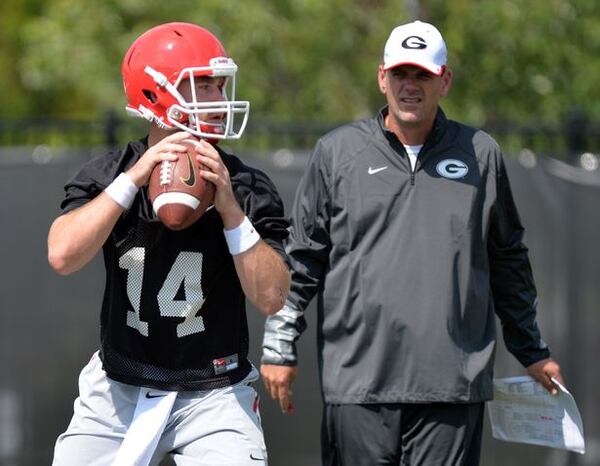 Mike Bobo, shown with Hutson Mason, is interviewing for the Colorado State job. (Brant Sanderlin/AJC photo)