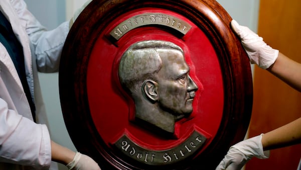 Members of the federal police show a bust relief portrait of Nazi leader Adolf Hitler at the Interpol headquarters in Buenos Aires, Argentina, Friday, June 16, 2017. In a hidden room in a house near Argentina's capital, police discovered on June 8th the biggest collection of Nazi artifacts in the country's history. Authorities say they suspect they are originals that belonged to high-ranking Nazis in Germany during World War II. (AP Photo/Natacha Pisarenko)