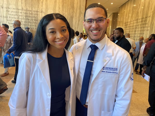 Medical students Peyton Pritchett and Juan Gomez are shown just after their Morehouse School of Medicine "white coat ceremony," where students for the first time don white medical coats they will wear in clinical settings. The students' coats are shorter than the ones full doctors wear. The convocation was at Morehouse College's Martin Luther King, Jr. International Chapel on Friday, September 20, 2024. (Photo by Ariel Hart)