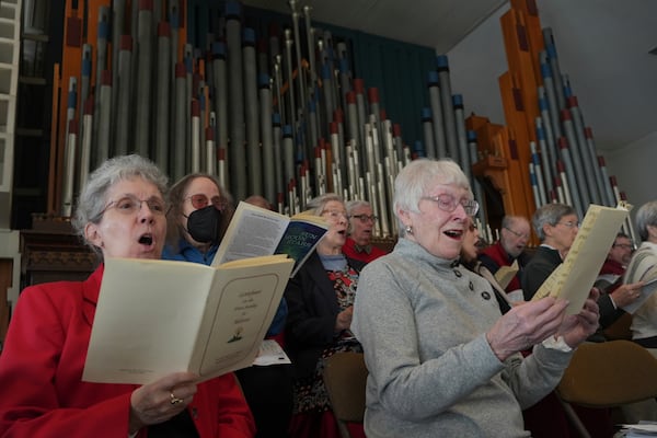 FILE - Members of the choir at Central Moravian Church sing at a "Lovefeast" service in Bethlehem, Pa., Dec. 1, 2024. (AP Photo/Luis Andres Henao, File)