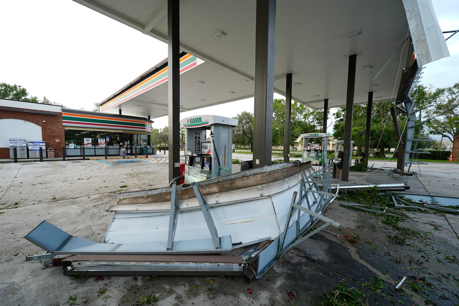 Debris and an awning of a gas station sits on the ground the morning after Hurricane Milton hit the region, Thursday, Oct. 10, 2024, in Tampa, Fla. (AP Photo/Julio Cortez)