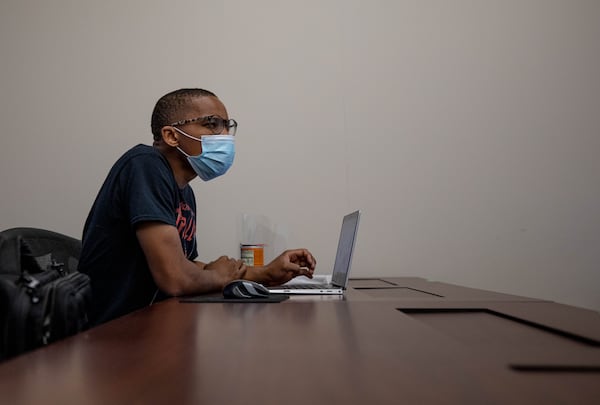 Kennesaw State University graduate student Siphiwe Msimanga listens to a lecture during an Information Technology class in Marietta. (BRANDEN CAMP FOR THE ATLANTA JOURNAL-CONSTITUTION)