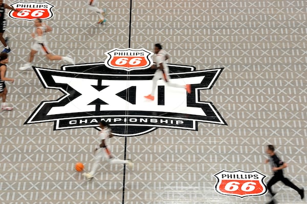 The Big 12 logo is seen on the court during the second half of an NCAA college basketball game between Cincinnati and Oklahoma State in the first round of the Big 12 Conference tournament, Tuesday, March 11, 2025, in Kansas City, Mo. (AP Photo/Charlie Riedel)