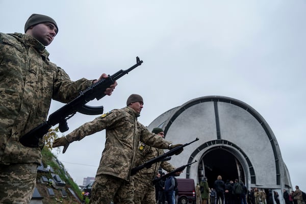 Honour Guard prepares to fire into the air during the funeral ceremony of Ukrainian serviceman of 3rd assault brigade Danylo Liashkevych aka "Berserk" and his girlfriend Valentyna Nagorna aka "Valkiria", at crematorium in Kyiv, Ukraine, Friday, Nov. 8, 2024. (AP Photo/Evgeniy Maloletka)