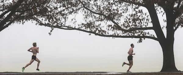 Wilkerson Givens (left) and Matt McDonald (right) of the Atlanta Track Club get in a warm, foggy 9-miles at Piedmont Park on Friday, Feb. 22, 2019 as they trained for the upcoming Boston Marathon.