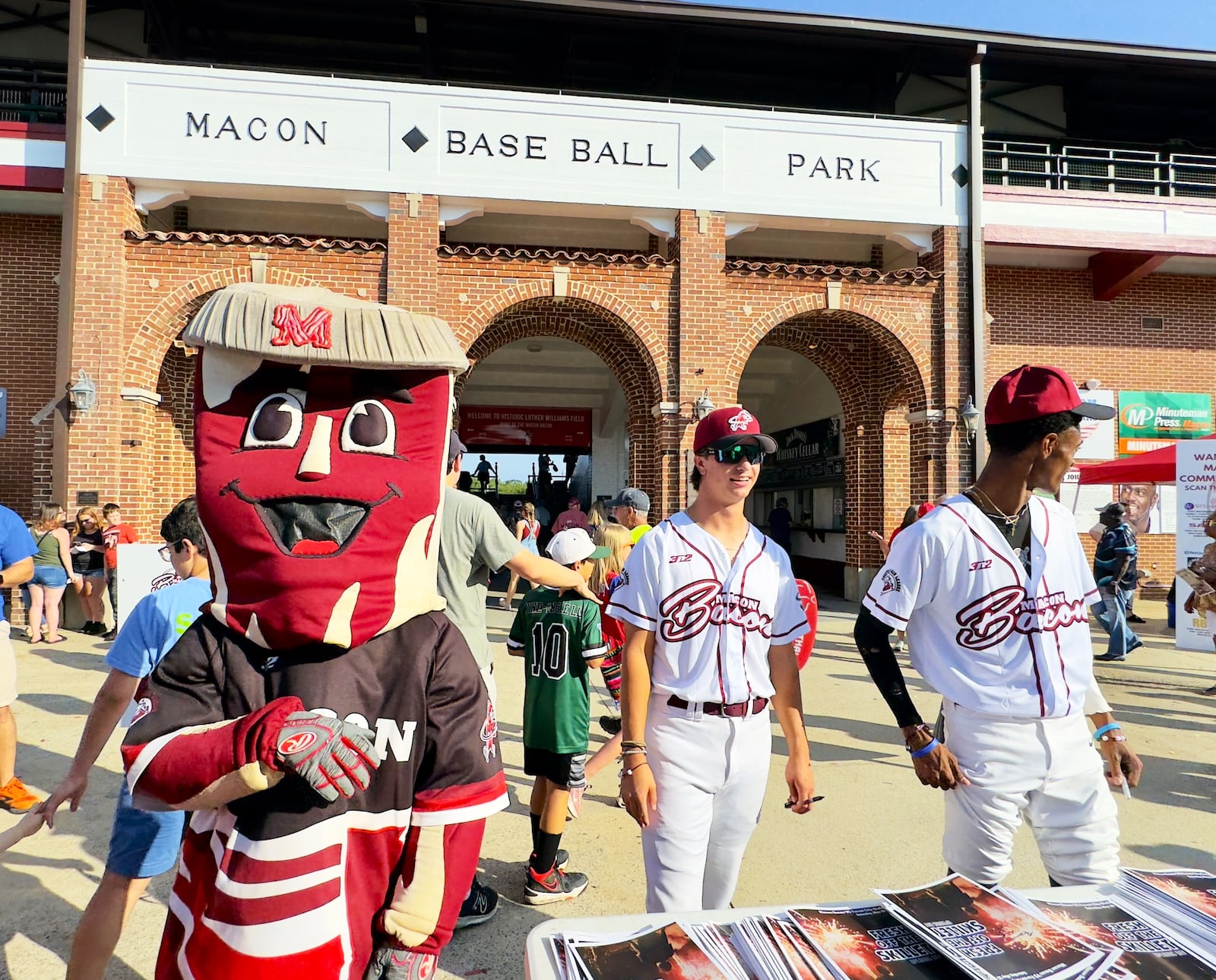 Macon Bacon mascot "Kevin Bacon" welcomes fans to Luther Williams Field in Macon on opening night 2024. (Joe Kovac Jr. / AJC)