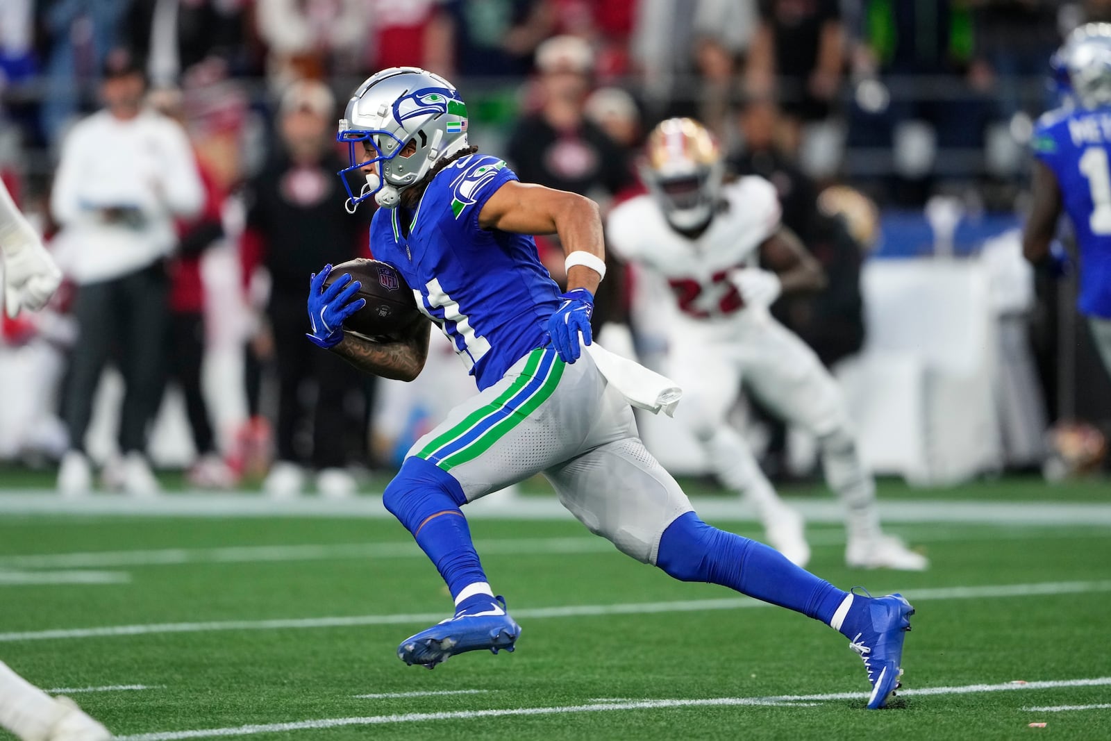 Seattle Seahawks' Jaxon Smith-Njigba runs during the first half of an NFL football game against the San Francisco 49ers, Thursday, Oct. 10, 2024, in Seattle. (AP Photo/Lindsey Wasson)