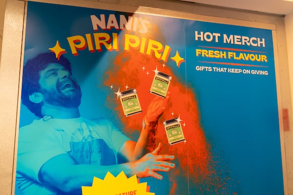 This Nani’s Piri Piri Chicken poster shows owner Meherwan Irani.  (Mia Yakel for The Atlanta Journal-Constitution)