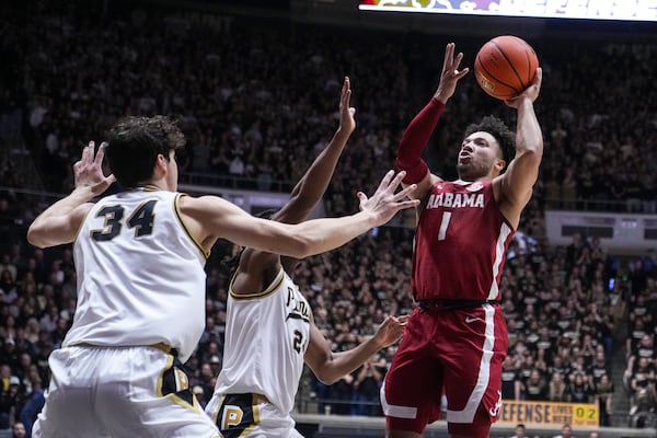 Alabama guard Mark Sears (1) shoots over Purdue forward Raleigh Burgess (34) during the first half of an NCAA college basketball game in West Lafayette, Ind., Friday, Nov. 15, 2024. (AP Photo/Michael Conroy)