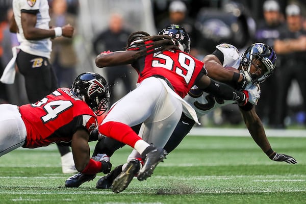 12/02/2018 -- Atlanta, Georgia -- Atlanta Falcons linebacker Foye Oluokun (54) tackles Baltimore Ravens cornerback Tavon Young (25) during the second half of the game at Mercedes-Benz Stadium in Atlanta, Sunday, December 2, 2018.  The Baltimore Ravens beat the Atlanta Falcons, 26-16. (ALYSSA POINTER/ALYSSA.POINTER@AJC.COM)