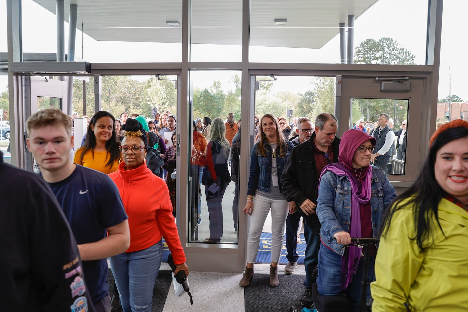 Parents, students and faculty walk through the front doors of Eastvalley Elementary School in Marietta to tour the new campus on Monday, Oct. 16, 2023. (Natrice Miller/ Natrice.miller@ajc.com)