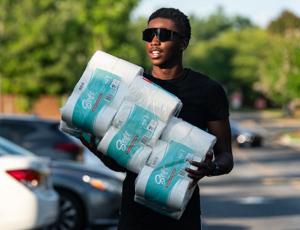 Incoming senior Kaleb Whitlow carries rolls of toilet paper to throw at Marietta High School in Marietta, GA on Wednesday, July 31, 2024. (Seeger Gray / AJC)