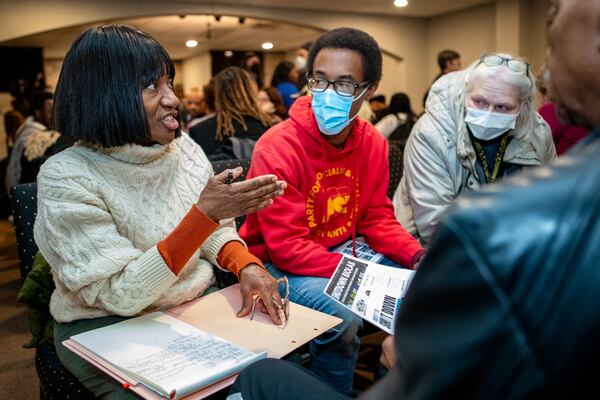 Rockdale County community members are gathering Tuesday, December 3, 2024 at Movement Church to support the revocation of BioLab's business license after the recent chemical fire. Residents and activists, including Deborah Middleton, from left, Bezaleel Jupiter and Ruth Kelvy gathered in a small group to list their biggest concerns. (Jenni Girtman for The Atlanta Journal-Constitution)