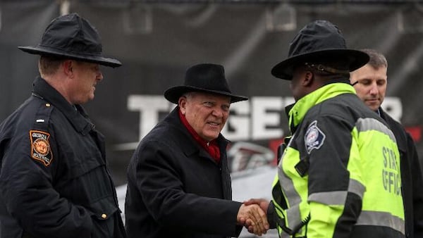 Governor Nathan Deal greets Georgia State Troopers as he arrives to the victory rally stage at the Home Depot Backyard. (Alyssa Pointer/AJC Staff)