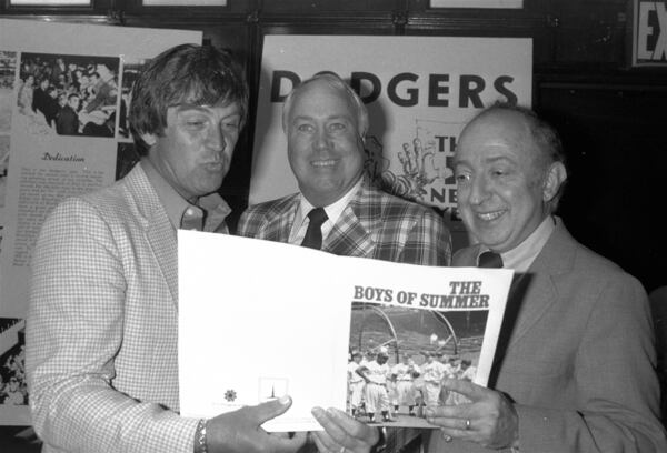 In this June 24, 1982, file photo, author Roger Kahn, right, joins former Brooklyn Dodgers outfielder Duke Snider, center, and former Dodgers pitcher Clem Labine at the start of production on the television film based on Kahn’s bestselling book, “The Boys of Summer.”