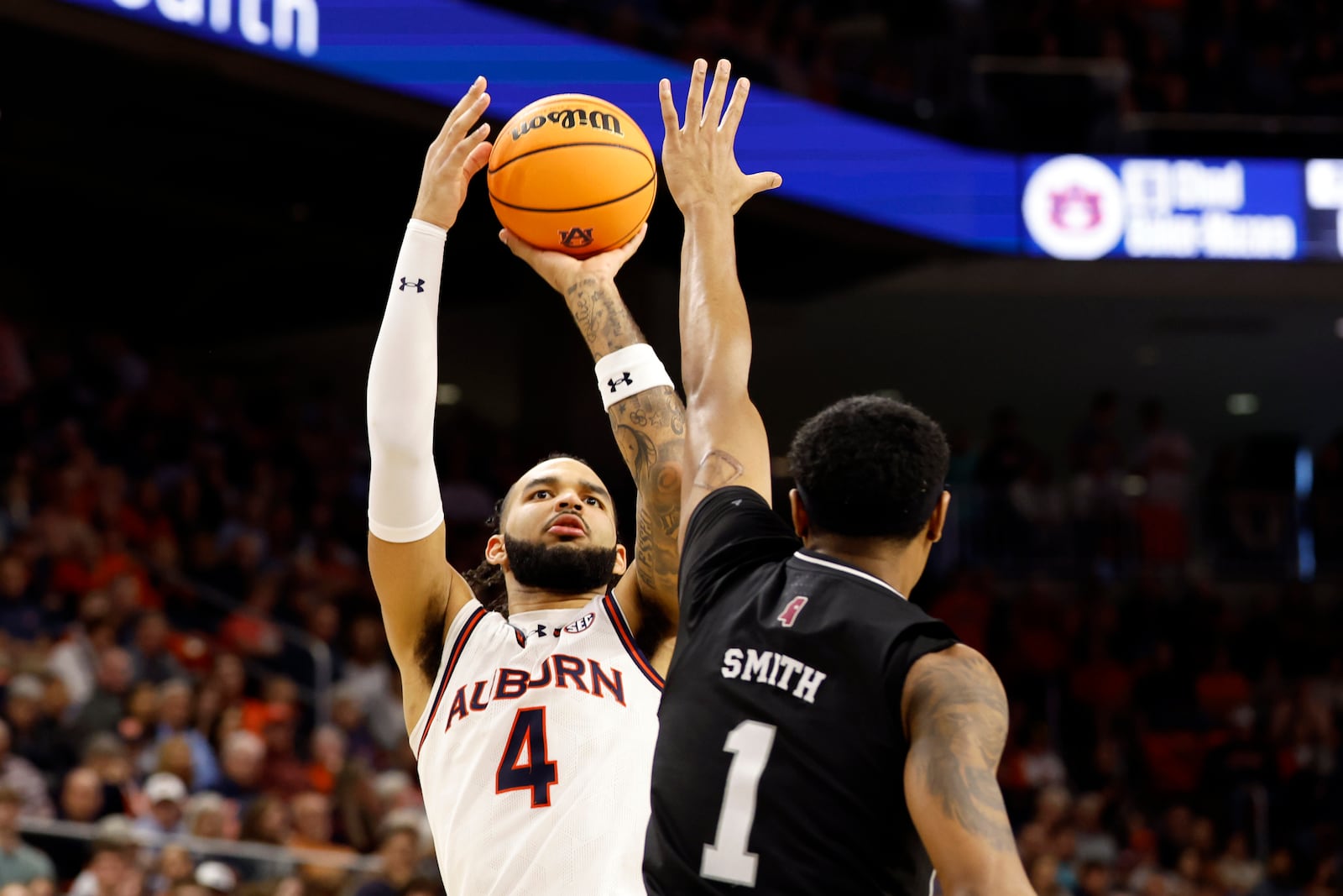 FILE - Auburn forward Johni Broome (4) shoots over Mississippi State forward Tolu Smith (1) during the second half of an NCAA college basketball game, Saturday, March 2, 2024, in Auburn, Ala. (AP Photo/ Butch Dill, File)