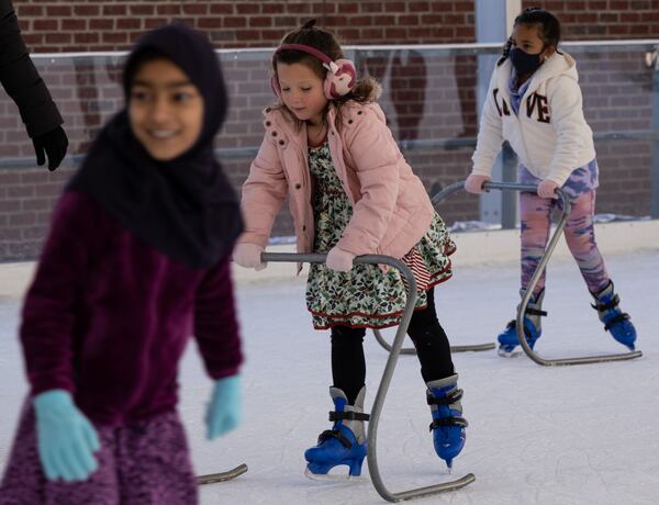 Mila Cranford, 6, of Flowery Branch, uses an ice skating trainer while skating at the Have an Ice Day rink in downtown Sugar Hill on Saturday afternoon, December 26, 2020. (Photo: Ben Gray for The Atlanta Journal-Constitution)