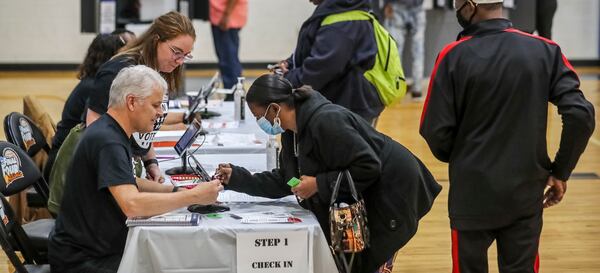 November 8, 2022 Fulton County: Voters check in on Tuesday, Nov. 8, 2022 at the Dunbar Neighborhood Center located at 477 Windsor Street SW in Atlanta. Voters hit the polls on Tuesday, Nov. 8, 2022 for Election Day that was expected to bring high turnout to over 2,400 polling places across Georgia, where voters will cast ballots on touchscreens that print out ballots. Then results will begin to pour in soon after polls close at 7 p.m. Tuesday. State law requires runoffs when no candidate receives over 50% of the vote, which can occur in races with Democratic, Libertarian and Republican candidates. According to last yearÕs voting law, runoffs would be held four weeks after Election Day, on Dec. 6. Previously, runoffs were scheduled nine weeks after Election Day. (John Spink / John.Spink@ajc.com) 

