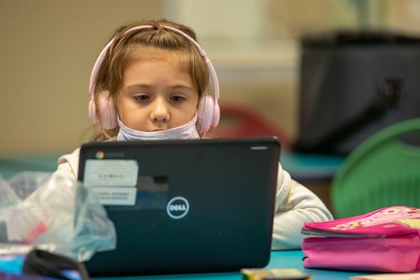 08/05/2020 - Marietta, Georgia - Rebekah Duarte participates in virtual learning on a laptop at the Emily Lembeck Learning Center in Marietta, Wednesday, August 5, 2020. The learning center is part of the Marietta City Schools district. The Marietta City School System is offering childcare for staff while the district is operating on a virtual-only option. Each class will be staffed by MCS staff members, and no more than five children will be in each class to allow for social distancing. (ALYSSA POINTER / ALYSSA.POINTER@AJC.COM)