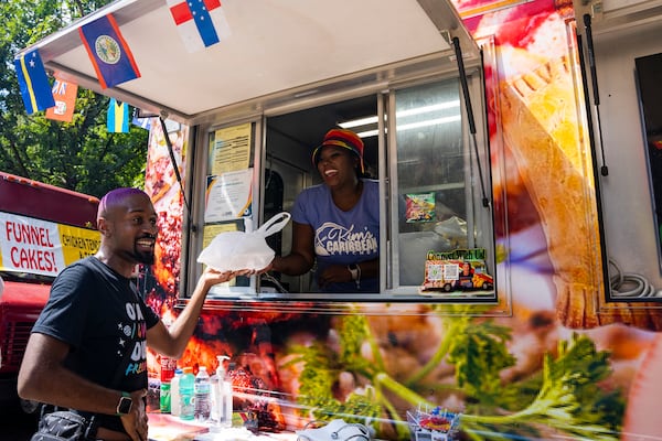 Kim's Caribbean Kitchen sells food at the Pure Heat Community Festival in Piedmont Park on Sunday, Sept. 1, 2024. (Olivia Bowdoin for the AJC). 