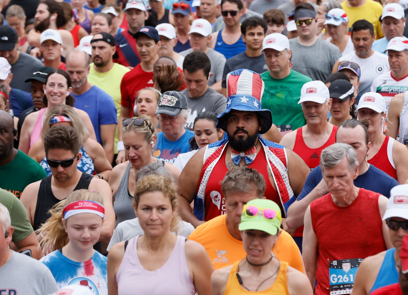 Runners take off at the start of the 54th running of the Atlanta Journal-Constitution Peachtree Road Race in Atlanta on Tuesday, July 4, 2023.   (Arvin Temkar / Arvin.Temkar@ajc.com)