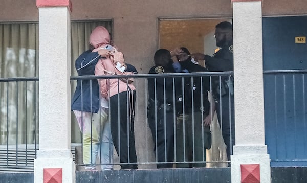 Grieving loved ones console each other at the Super 8 motel in College Park after a man was killed Monday morning.