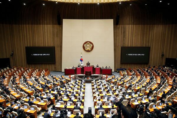 FILE - South Korean lawmakers attend during a plenary session of the impeachment vote of President Yoon Suk Yeol at the National Assembly in Seoul, on Dec. 14, 2024. (Woohae Cho/Pool Photo via AP, File)