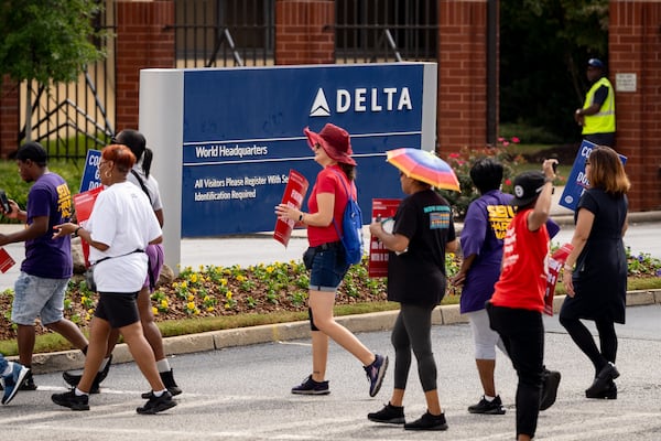 Endeavor Air flight attendants demonstrate outside of Delta headquarters in Atlanta on Thursday, Oct, 3, 2024. Demonstrators held signs and yelled chants demanding an end to tiered treatment. (Ben Hendren for the AJC)