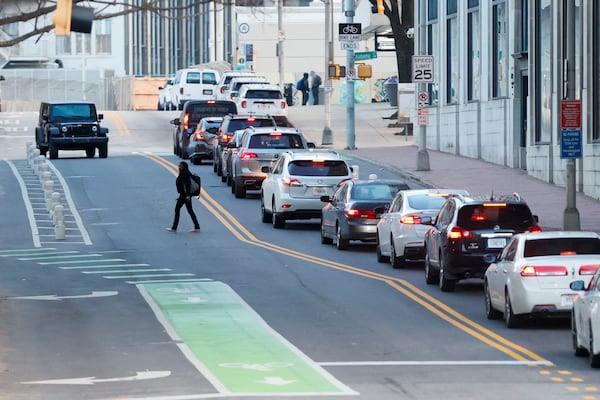 A pedestrian crosses Forsyth Street toward the Sam Nunn Atlanta Federal Center on Monday. This day marked the first full return-to-office day for numerous federal workers in downtown Atlanta. Miguel Martinez/AJC