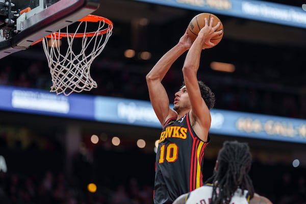 Atlanta Hawks forward Zaccharie Risacher (10) gies up for a dunk during the first half of an NBA basketball game against the Denver Nuggets on Sunday, Dec. 8, 2024, in Atlanta, at State Farm Arena. (Atlanta Journal-Constitution/Jason Allen)