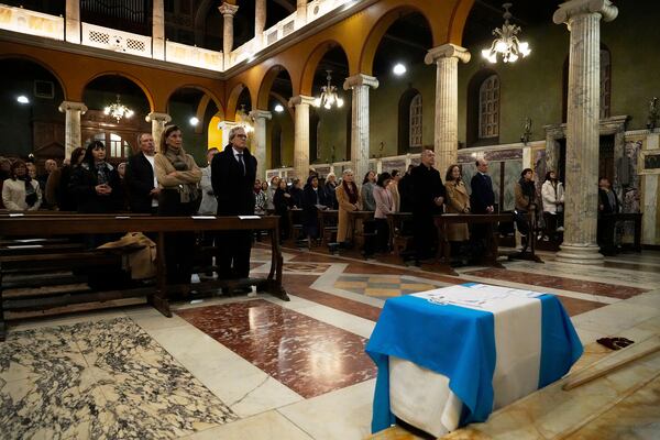 Faithful attend a thanksgiving mass on the 12th anniversary of Pope Francis election at the Argentinean's church in Rome, Thursday, March 13, 2025. (AP Photo/Gregorio Borgia)