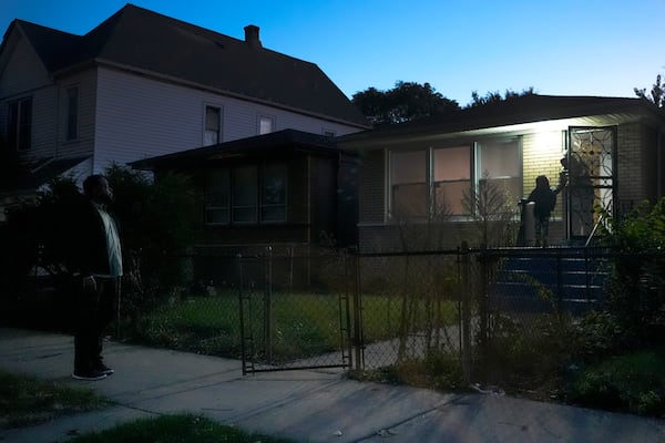 PiggyBack Network co-founder & CEO Ismael El-Amin waits outside the home of Messiah Robinson, 6, on Friday, Oct. 18, 2024, one of two children he will drive to school as part of the PiggyBack ride-share network in Chicago. (AP Photo/Charles Rex Arbogast)