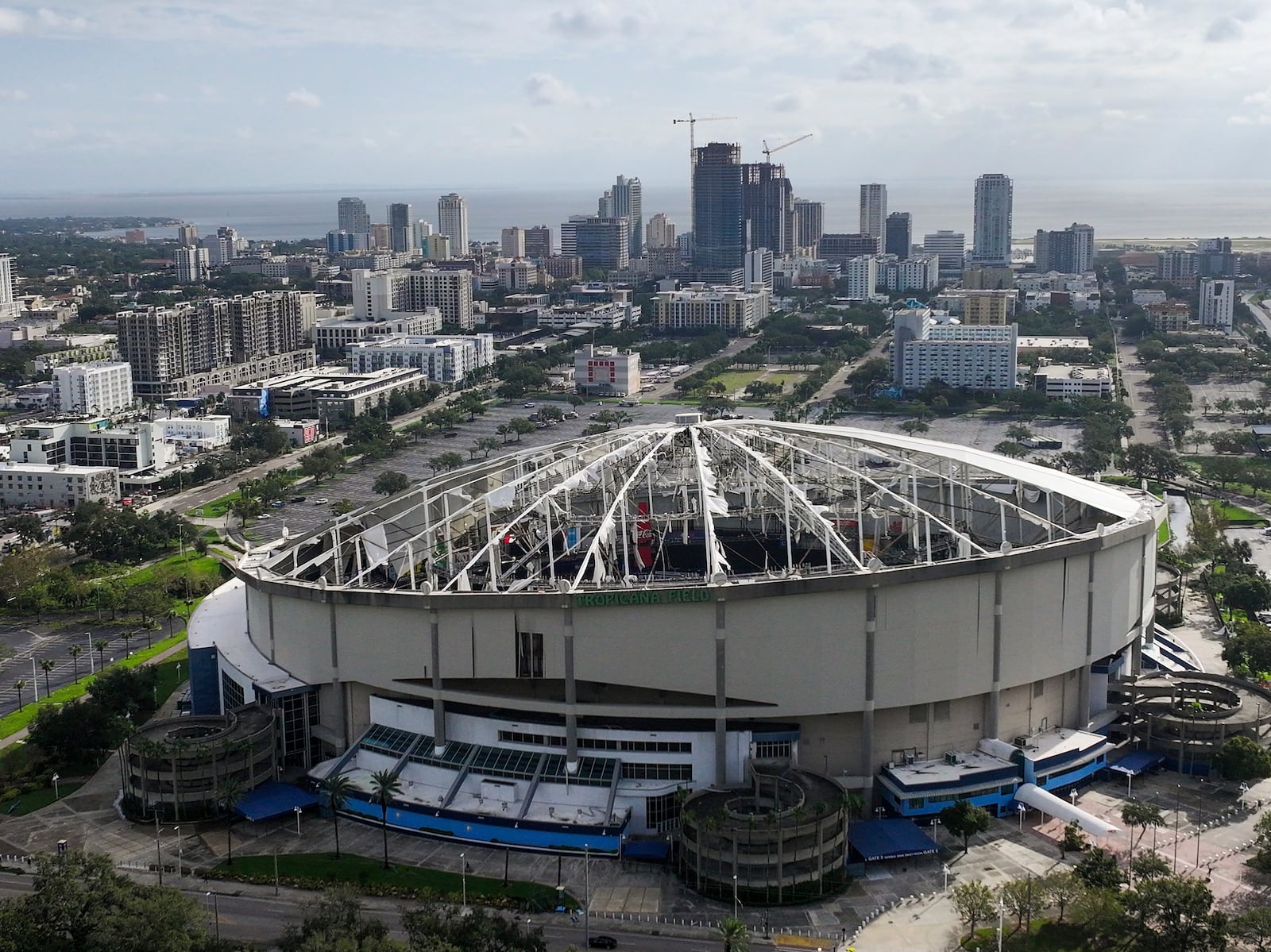 An aerial drone view of Tropicana Field with the roof shredded after Hurricane Milton with downtown St. Petersburg in the background on Thursday morning, Oct. 10, 2024. (Dirk Shadd/Tampa Bay Times via AP)