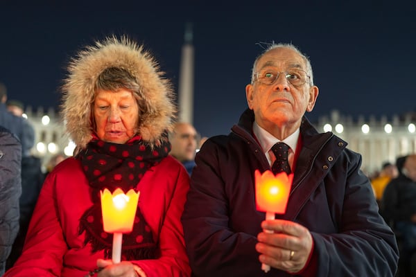 Catholic faithful attend a nightly rosary prayer for the health of Pope Francis in St. Peter's Square at the Vatican, Sunday, March 2, 2025. (AP Photo/Mosa'ab Elshamy)